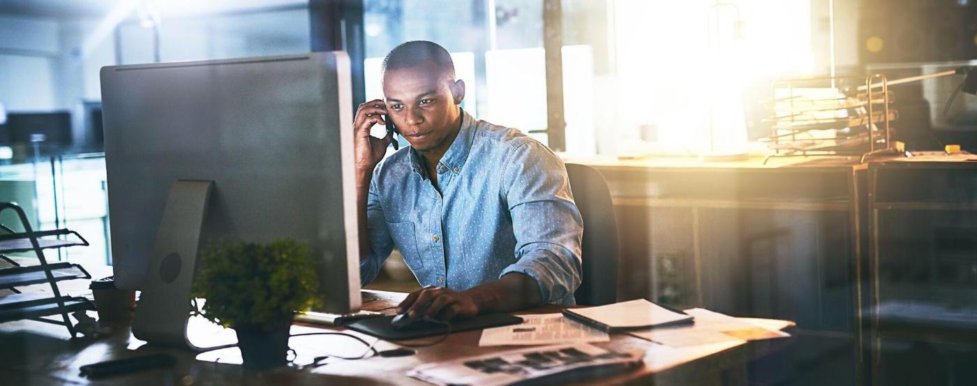 Businessman Takes a Call While Working